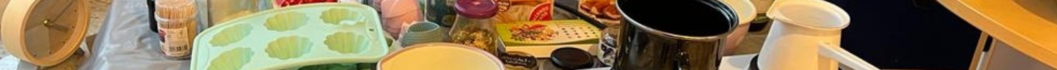 Ein Foto von Herdplatten mit Töpfen drauf, dahinter verschiedene Zutaten